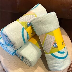 Set of 4 SunSquad Smiley Face Beach Towels.